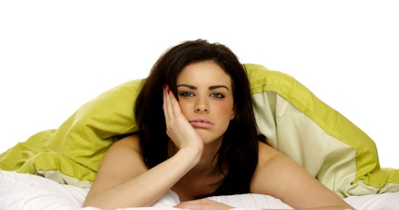 Woman awake in bed and unhappy