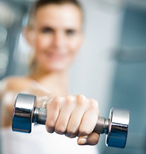 Close up of woman using hand weights
