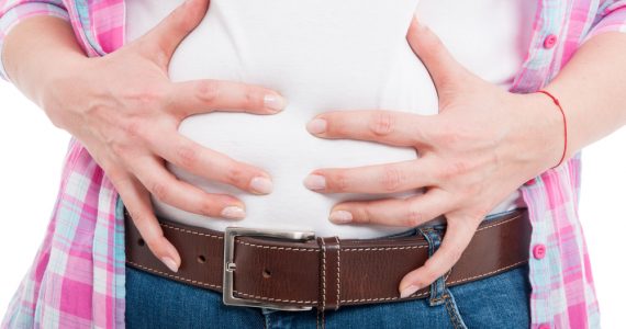 Close up of a woman's bloated stomach to represent IBS