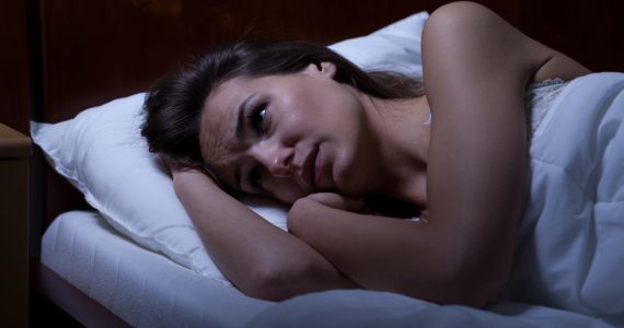 Close up of woman in bed unable to get to sleep