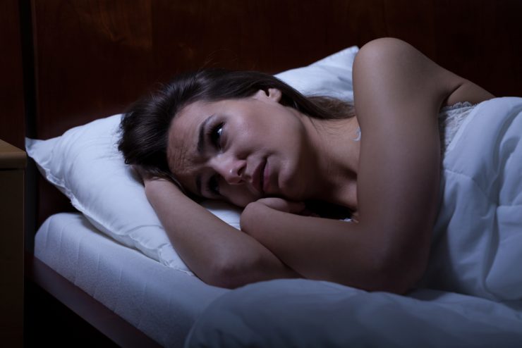 Close up of woman in bed unable to get to sleep