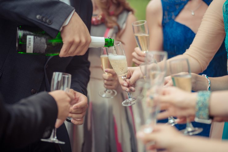 Close up of someone pouring a glass of champagne