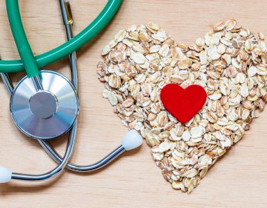 A stethoscope and oats in a heart shape to represent heart health