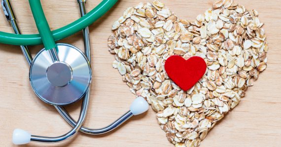 A stethoscope and oats in a heart shape to represent heart health