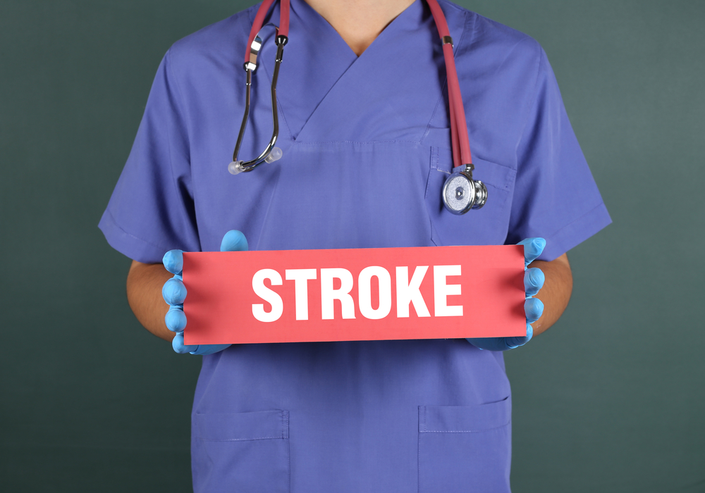 Doctor holding a sign with the word 'stroke' on it