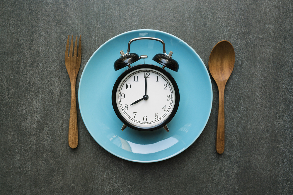 An alarm clock on a dinner plate to show meal times