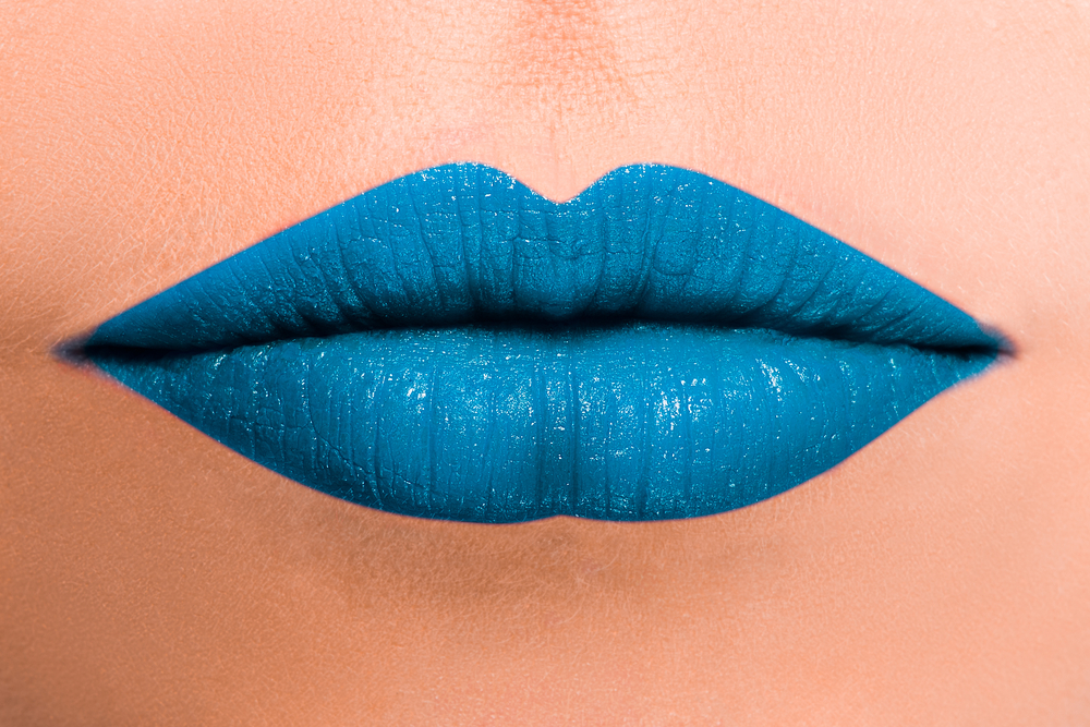 Close up of woman's lips in blue lipstick