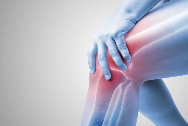 Close up of knee with glowing red showing joint pain