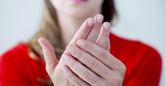 Close up of woman with painful hands due to Raynaud's syndrome