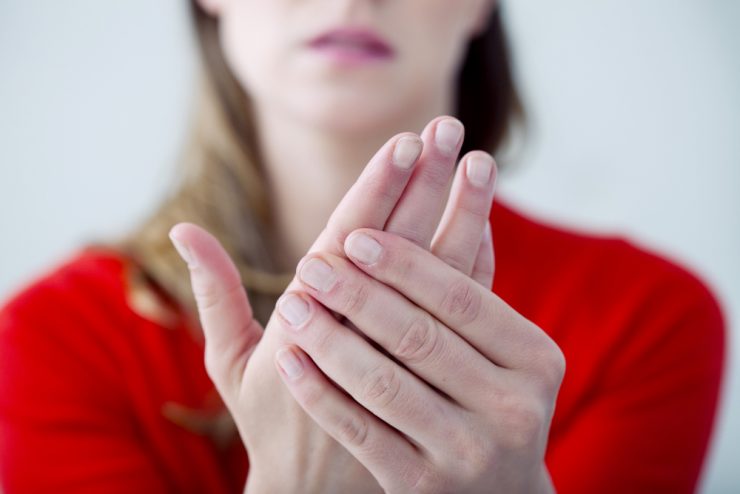 Close up of woman with painful hands due to Raynaud's syndrome