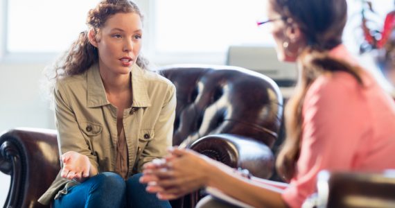 Two women talking to represent sharing problems to support mental health