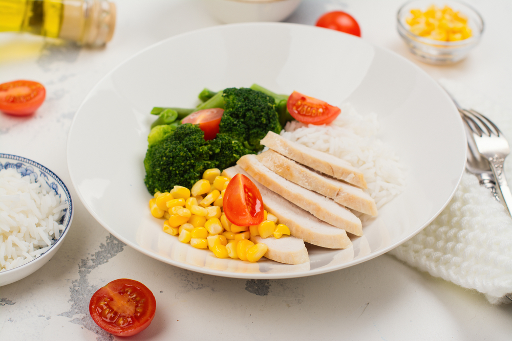 A plate of chicke, rice, broccoli and sweetcorn to represent a balanced meal