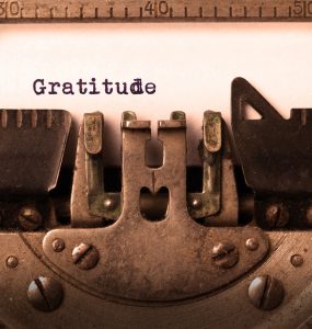 The word gratitude being typed with a typewriter