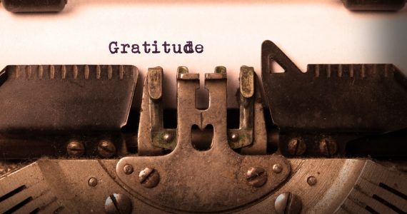 The word gratitude being typed with a typewriter