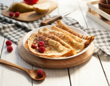 A plate of pancakes with berries