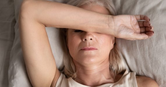 Close up of middle aged woman in bed struggling to sleep