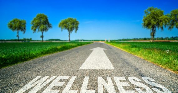 Road with the word 'Wellness' written on it with an arrow