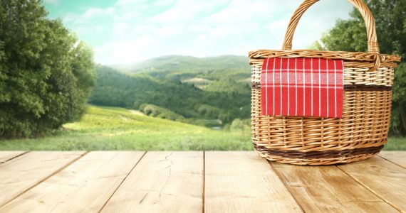 IMage of a picnic basket overlooking the countryside