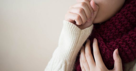 Close up of woman coughing