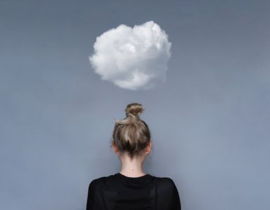 Woman with small cloud overhead to represent mental health worries