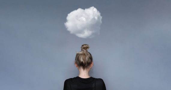 Woman with small cloud overhead to represent mental health worries