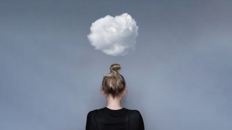 Woman with small cloud overhead to represent mental health worries
