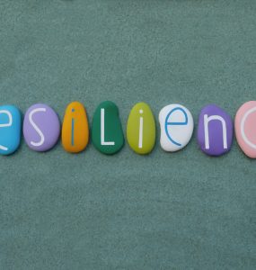 A set of pebbles spelling out the word resilience
