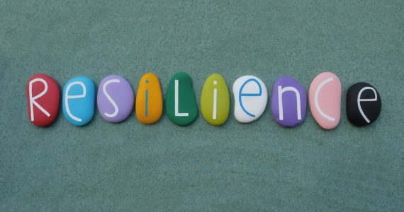 A set of pebbles spelling out the word resilience