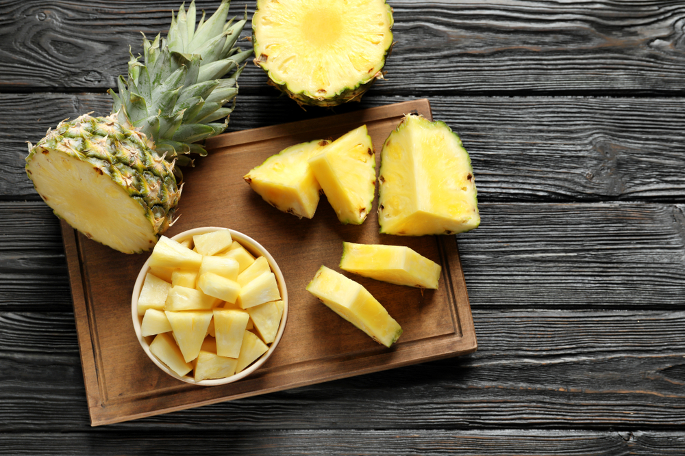 Pineapple whole and cut into a bowl